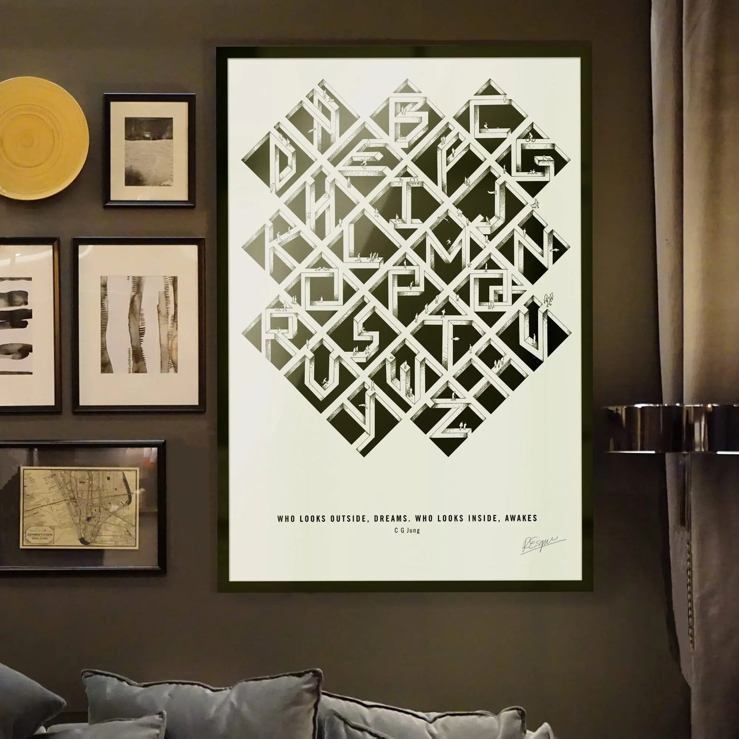 Alfalfabet typographic poster in black frame displayed on dark olive gallery wall with vintage art prints and modern brass sconces