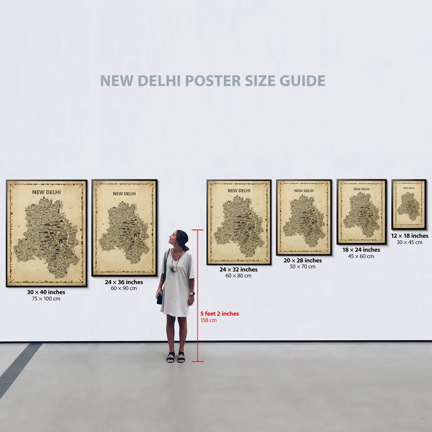 Poster size guide with New Delhi map designs and dimensions displayed on a wall.