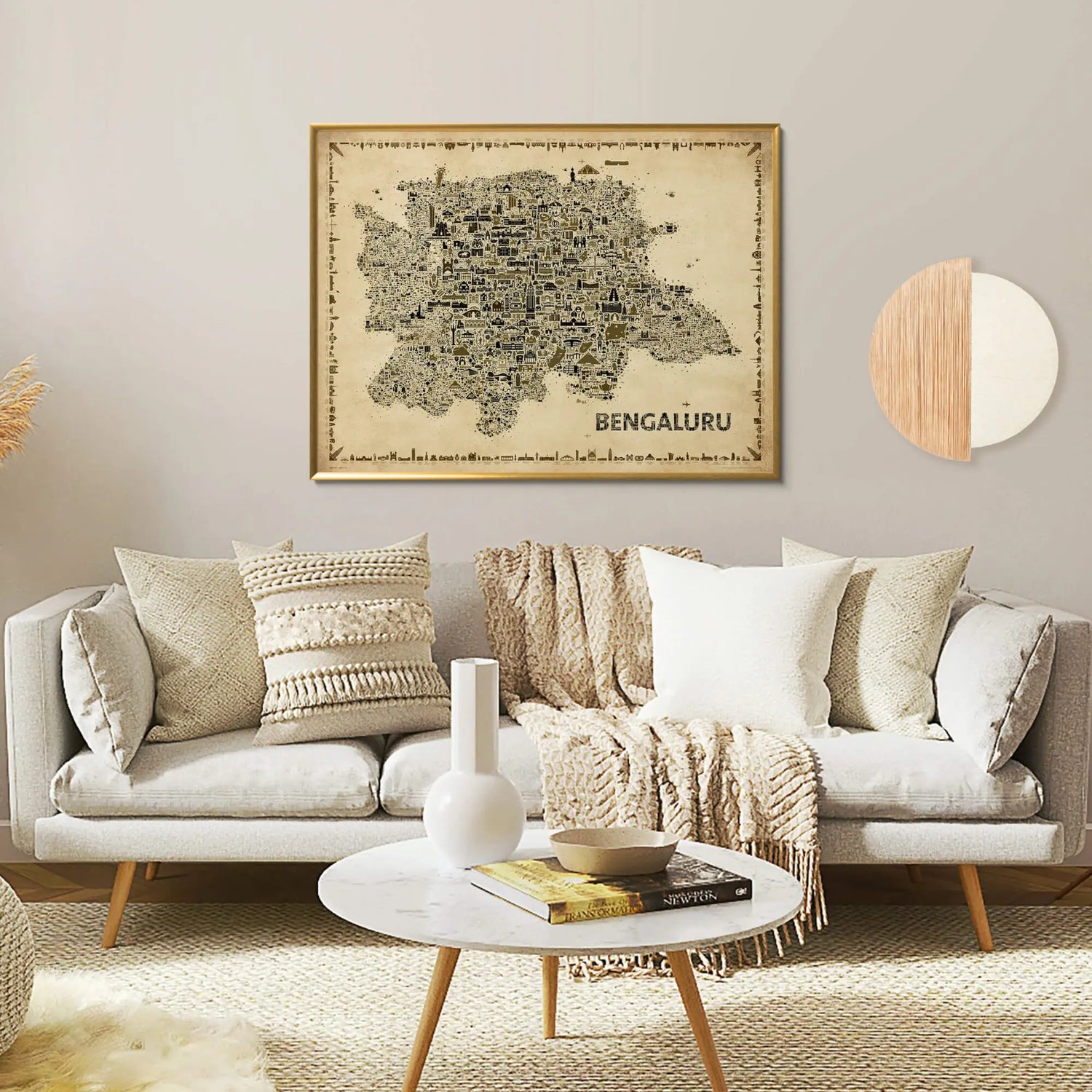 Living room with a gray sofa, decorative pillows, and a framed map of Bengaluru on the wall.