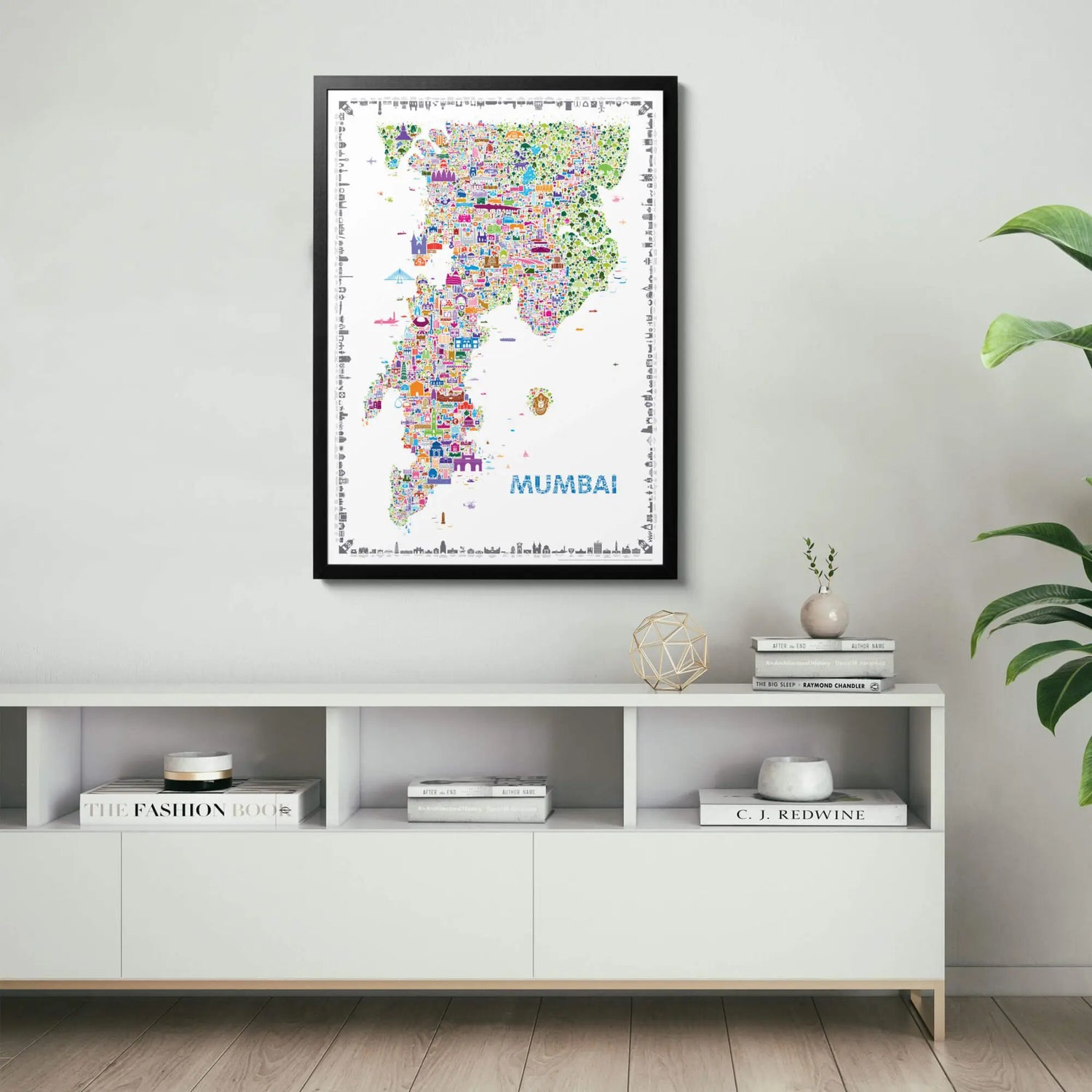 Framed map of Mumbai on a wall above a white shelf with decorative items.