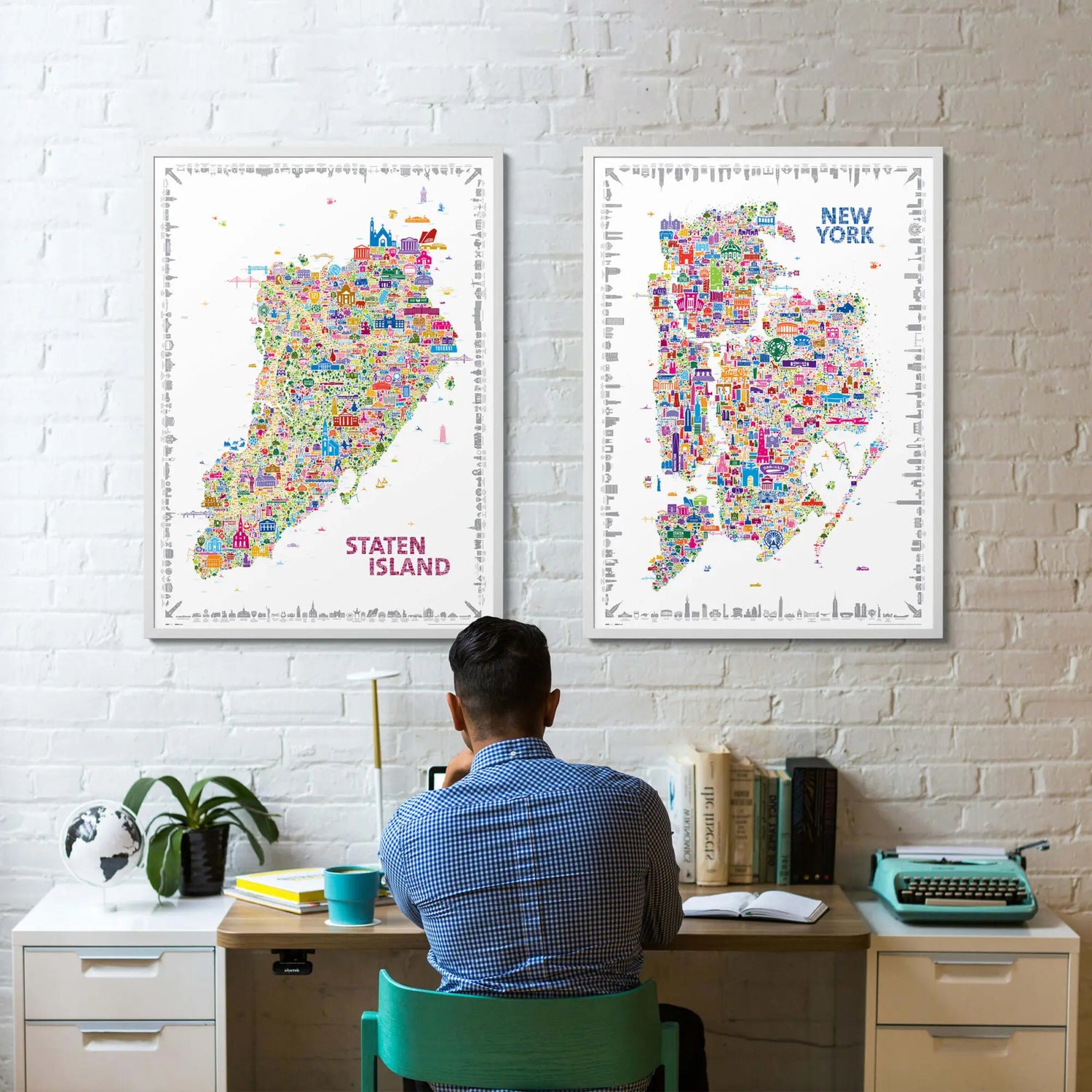 Person sitting at a desk with colorful Staten Island and New York maps on the wall.