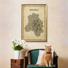 Cat sitting on a chair with a map of New Delhi framed above, against a beige wall.