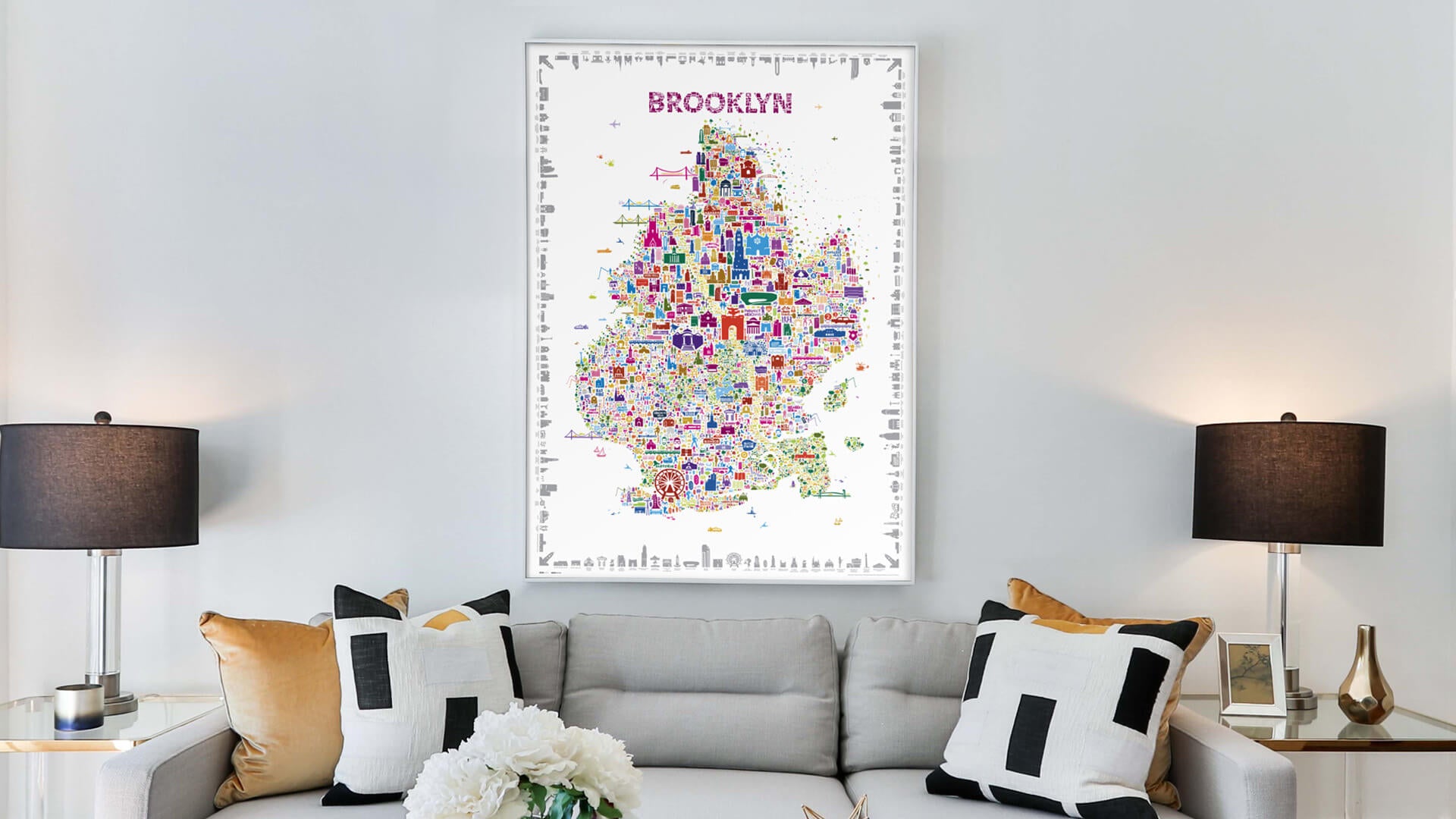 Colorful map of Brooklyn on a wall above a sofa in a living room.