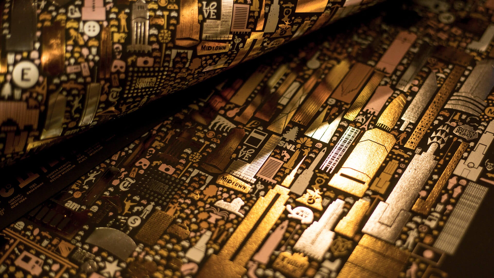 Artistic close-up detail of New York City illuminated map poster showing intricate building illustrations with dramatic lighting and golden tones