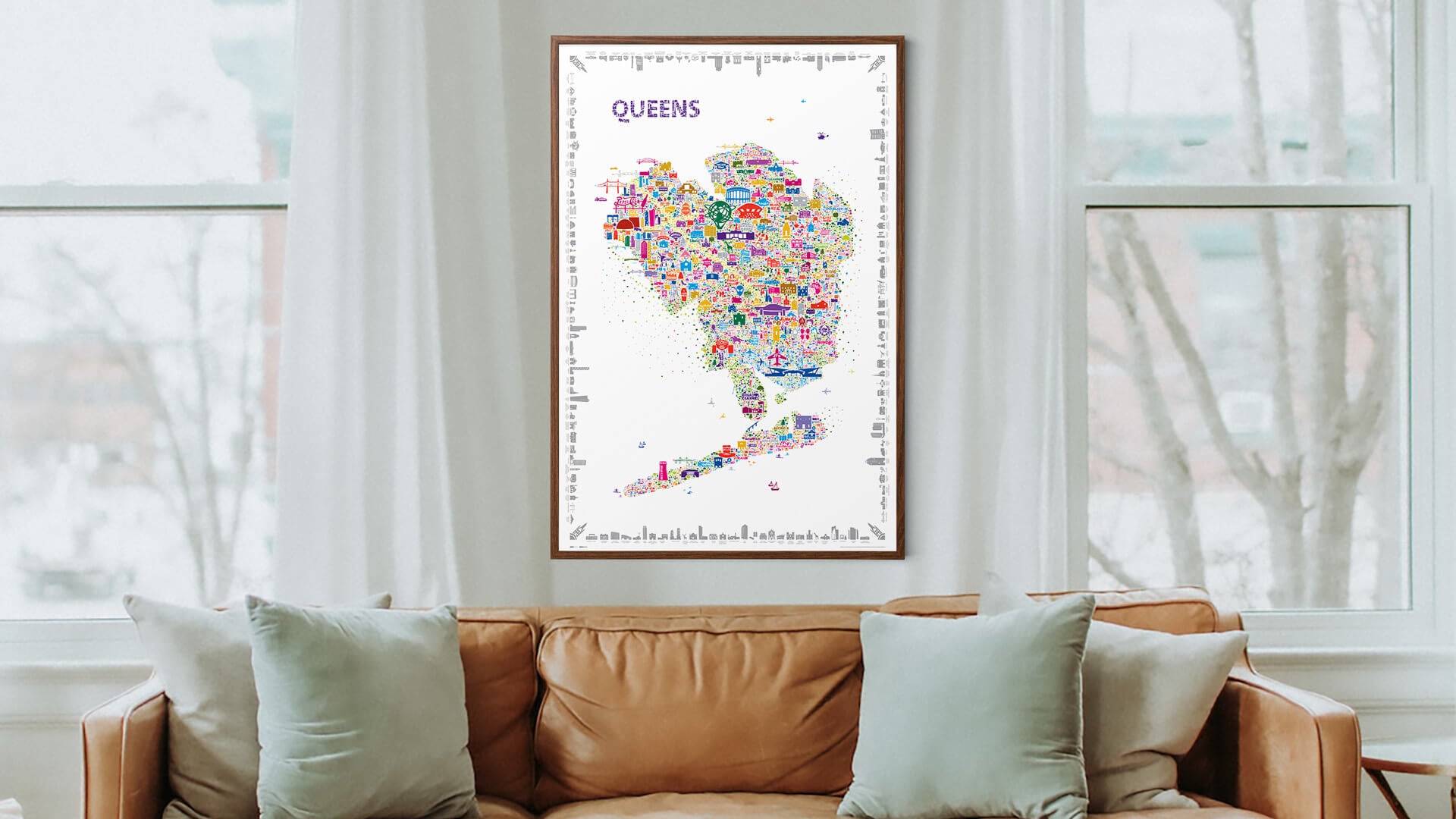 Colorful map of Queens on a wall in a living room with a couch and windows.