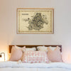 Framed map of Kolkata above a bed with decorative pillows.
