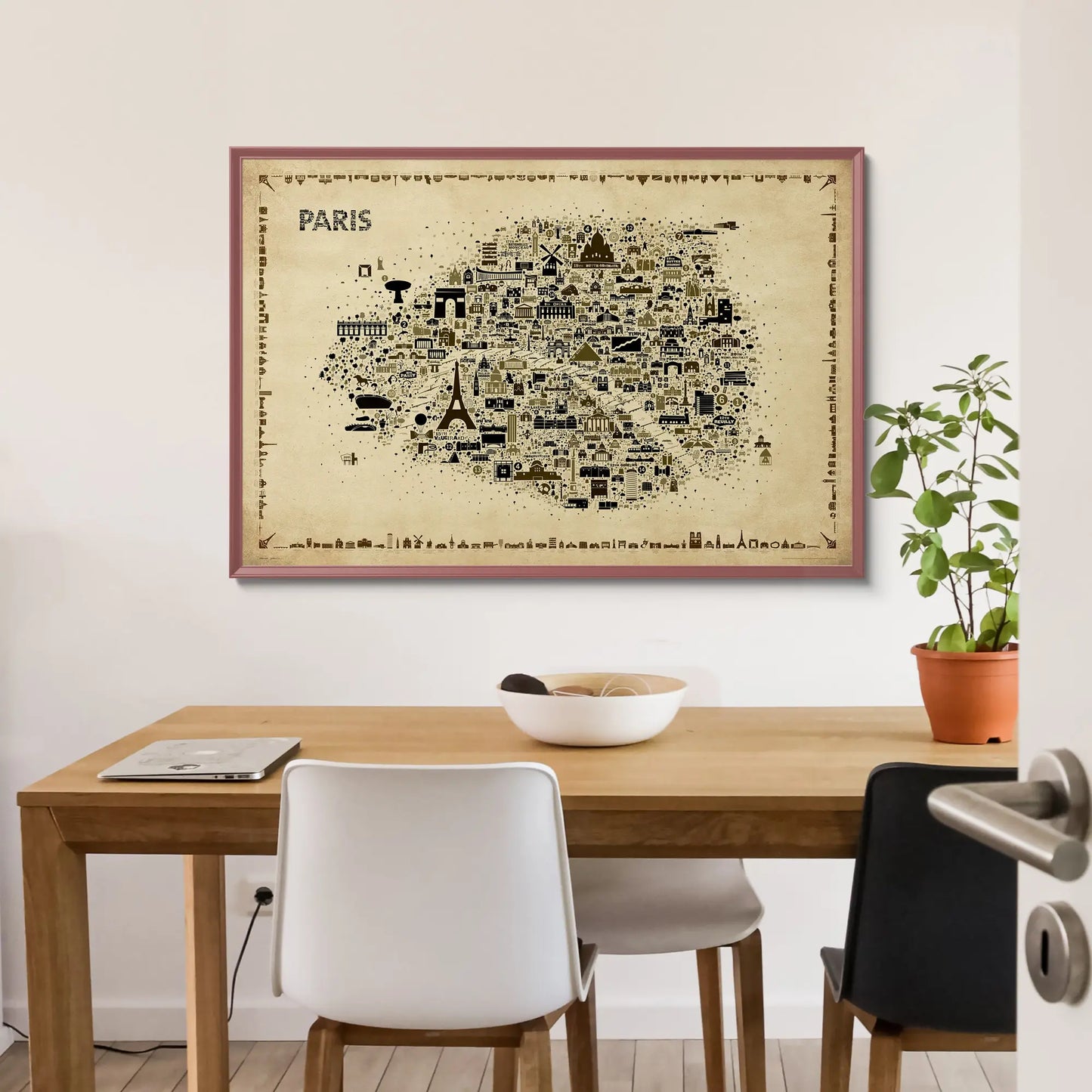 Framed map of Paris on a wall above a wooden table with chairs.