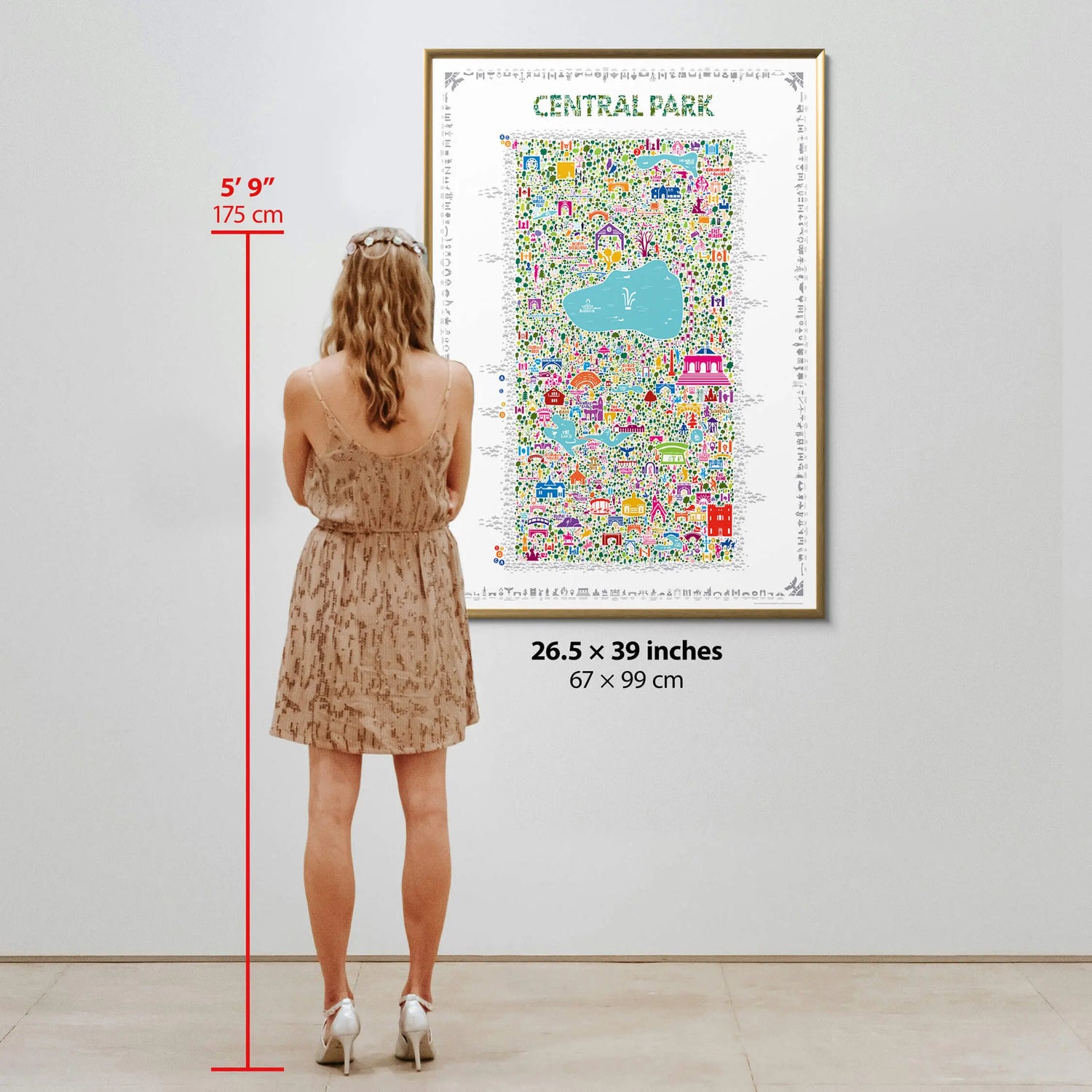 Central Park illustrated map art print size reference — woman 5 feet 9 inches (175 cm) tall standing beside 26.5 x 39 inch framed poster for scale, by Alfalfa New York.