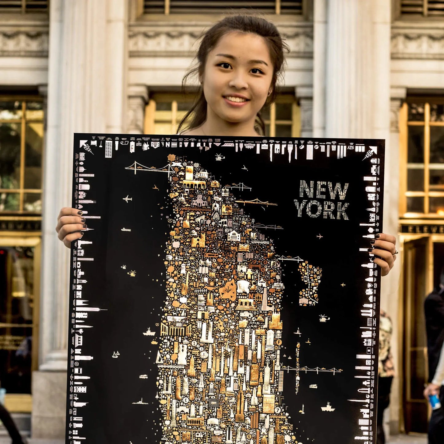 Person holding a detailed map of New York City