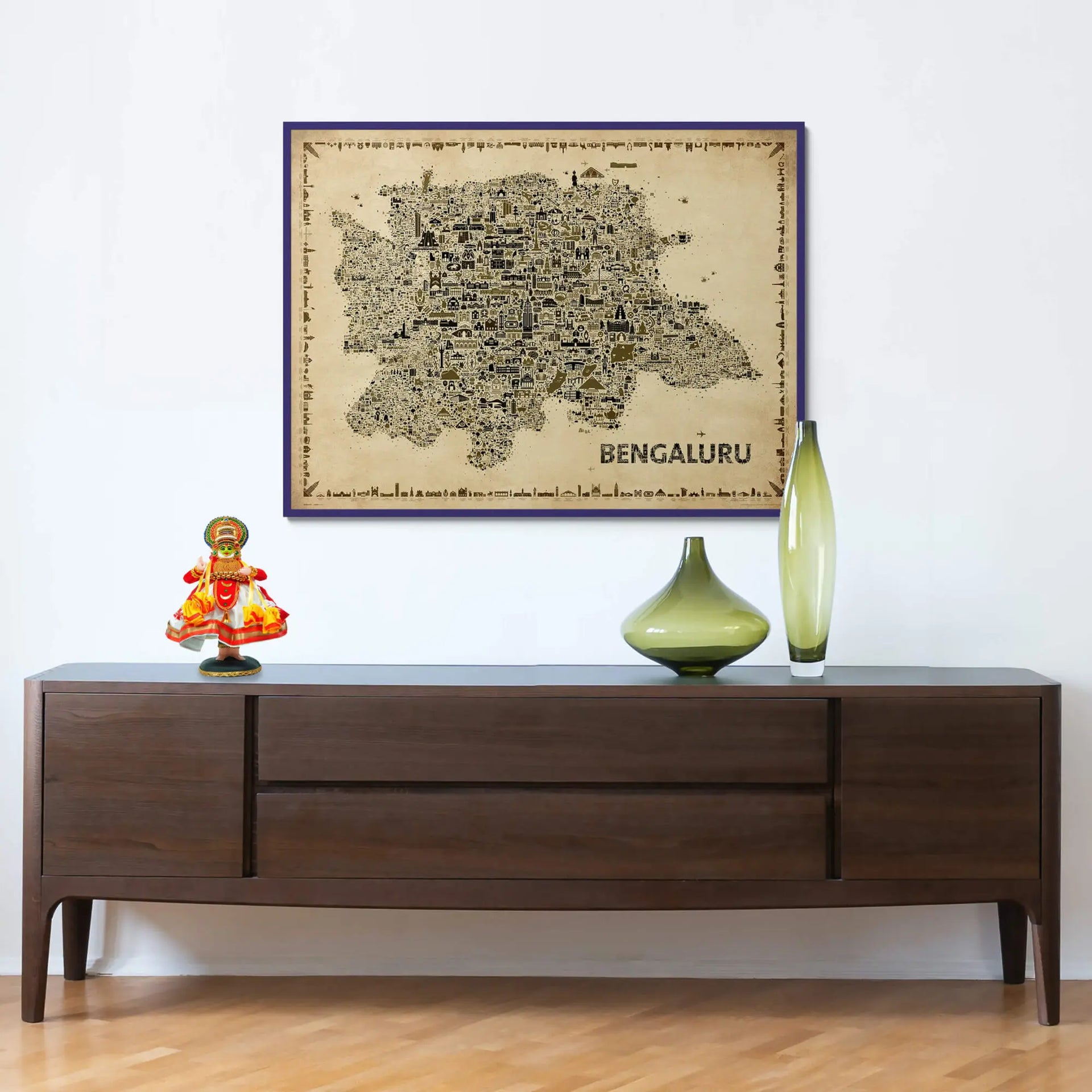Vintage Bengaluru city map art print framed and displayed above a dark wooden console with decorative glass vases and a traditional figurine in a modern home interior.
