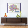 Framed map of Bengaluru on a wall above a wooden console table with decorative items.