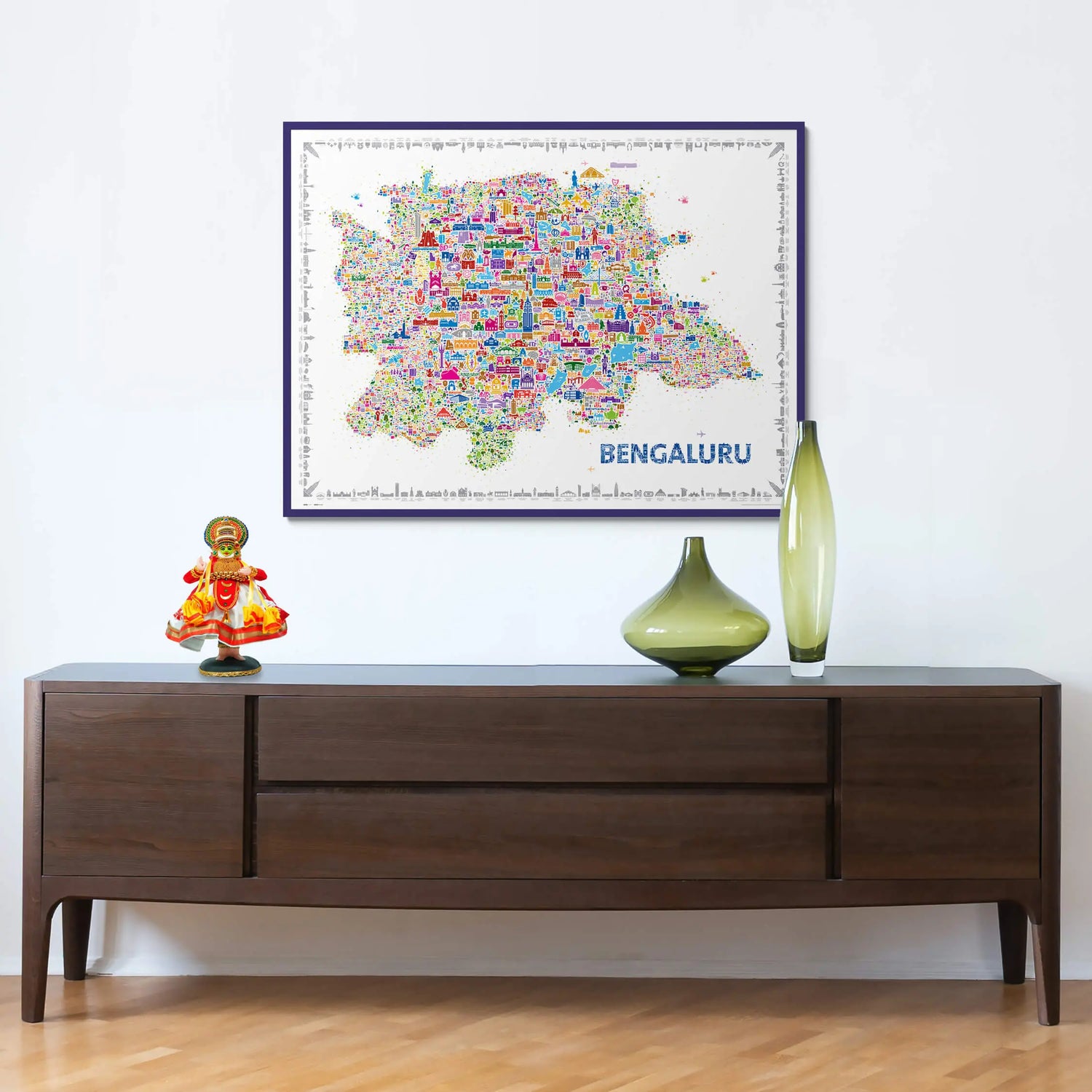 Framed map of Bengaluru on a wall above a wooden console table with decorative items.
