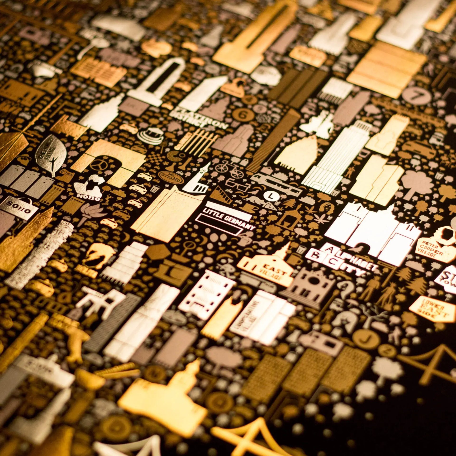 Close-up of a detailed map with various symbols and text on a dark background