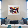East LA Lowrider Bike screenprint in a white frame above a cream sofa with teal and navy cushions and teal vases