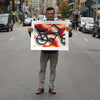 Rafael Esquer holding the full sheet of East LA Lowrider Bike, an unframed screenprint, on a New York street to show its size