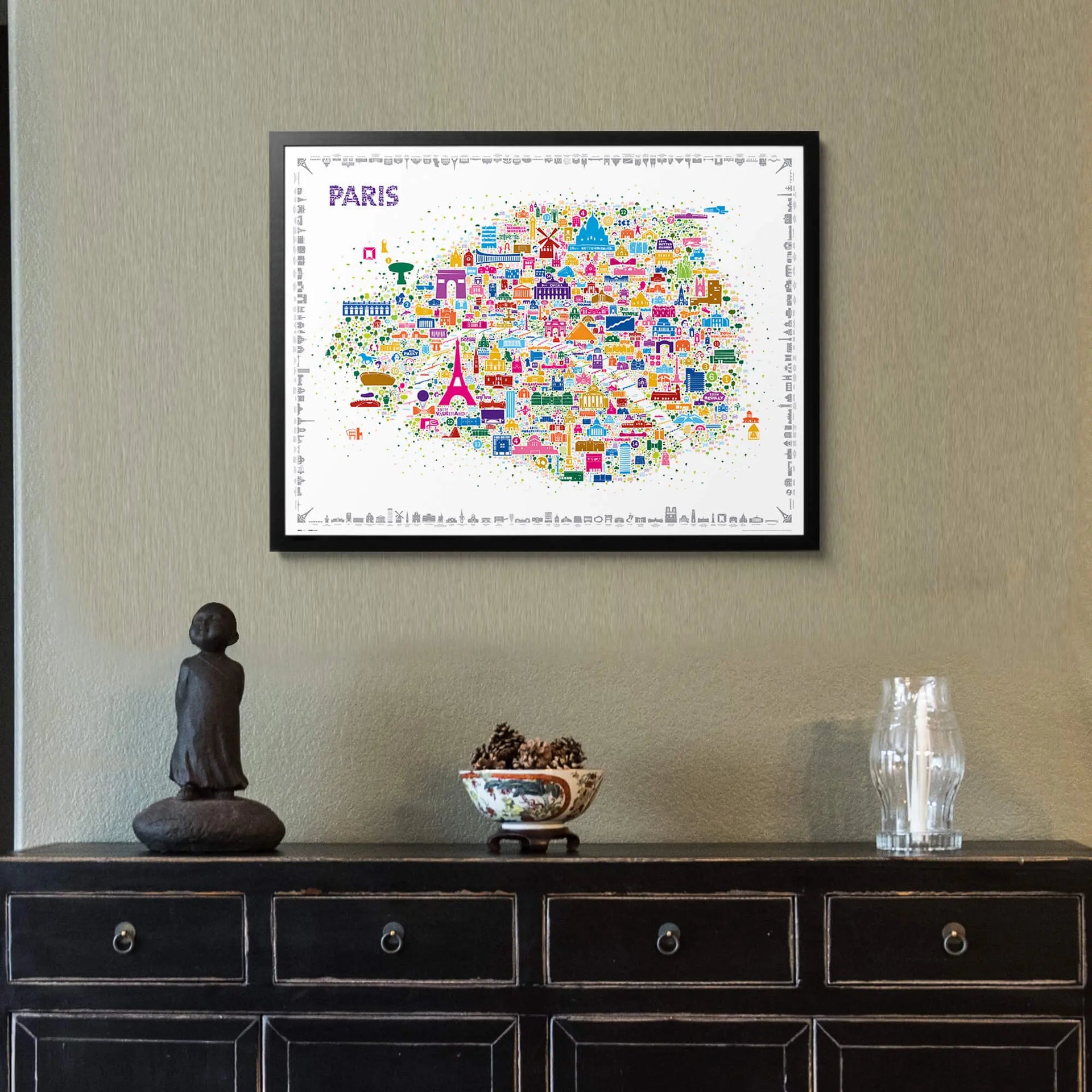 Iconic Paris colorful illustrated map poster in black frame displayed above elegant black console table with Buddha statue and crystal vase