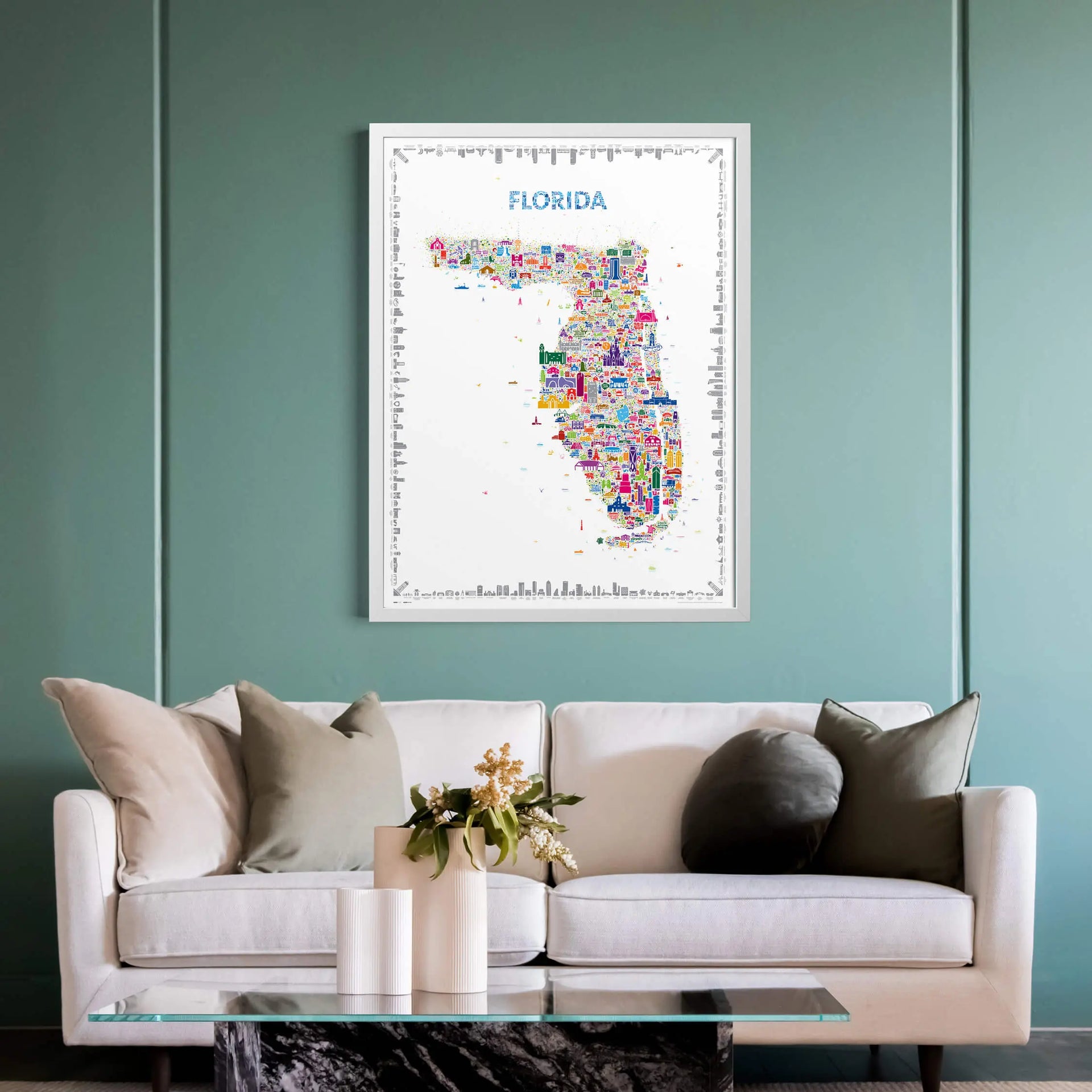 Colorful map of Florida on a wall above a white sofa with decorative pillows.