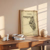 Florida antique map poster in sepia tones with natural wood frame on desk with books and sunlight, vintage travel wall art décor