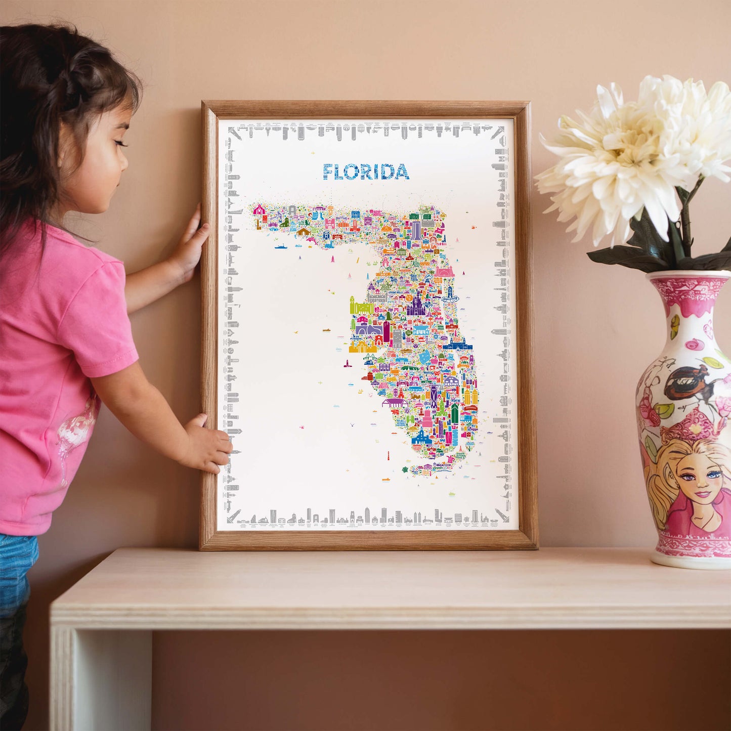 Florida map poster in natural wood frame with child interacting, colorful educational wall art inspiring curiosity and travel