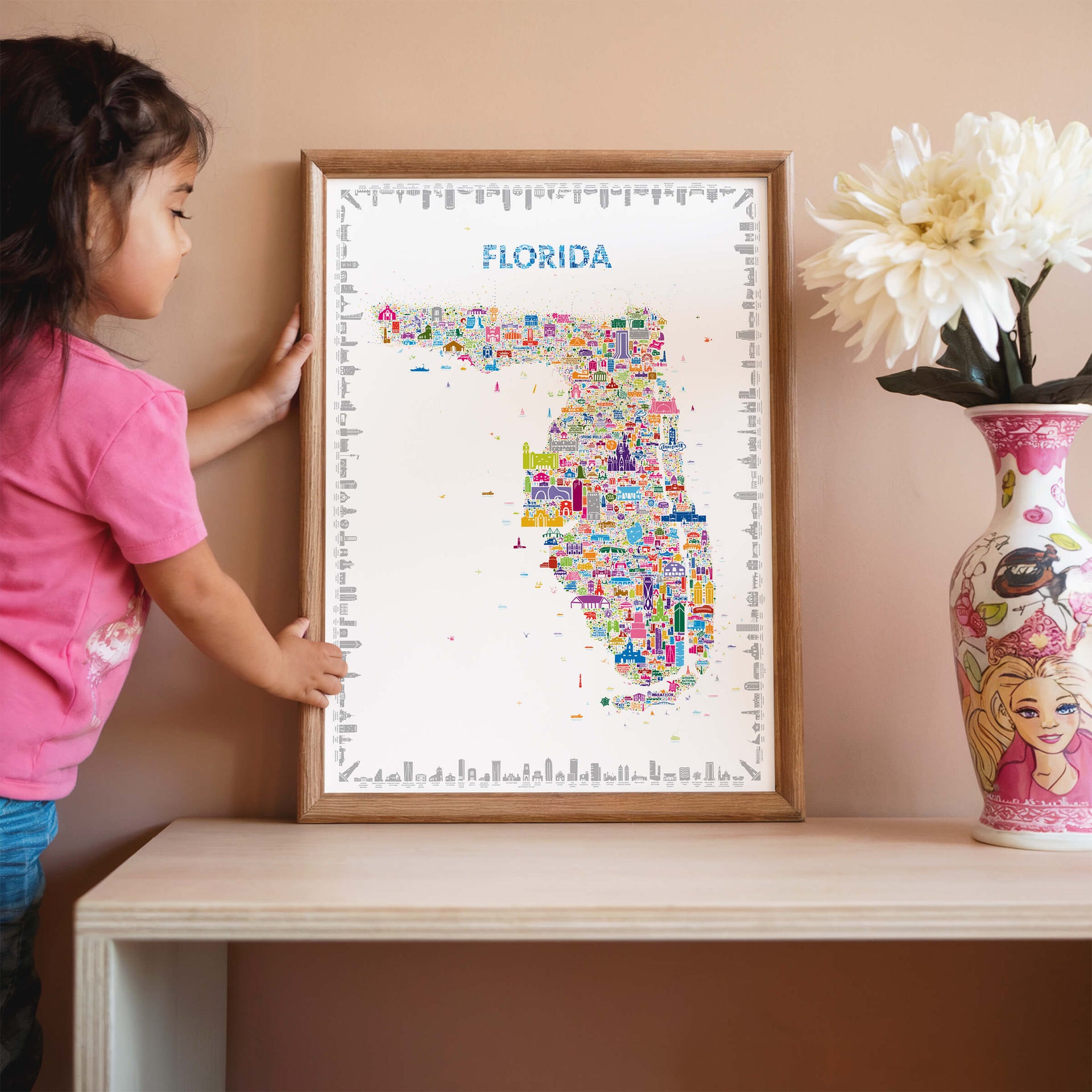 Florida map poster in natural wood frame with child interacting, colorful educational wall art inspiring curiosity and travel