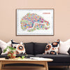 Framed map of London on a wall above a sofa with decorative pillows.