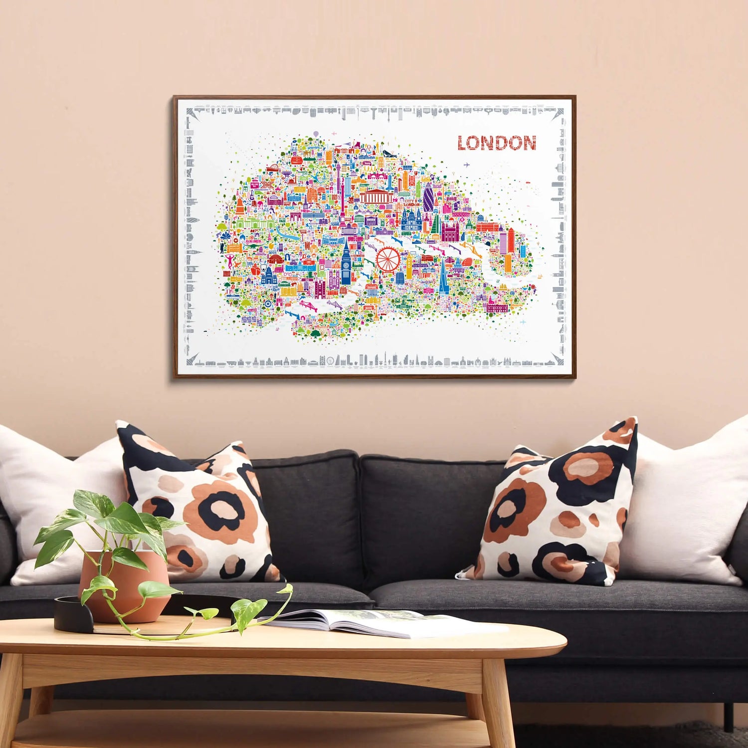 Framed map of London on a wall above a sofa with decorative pillows.