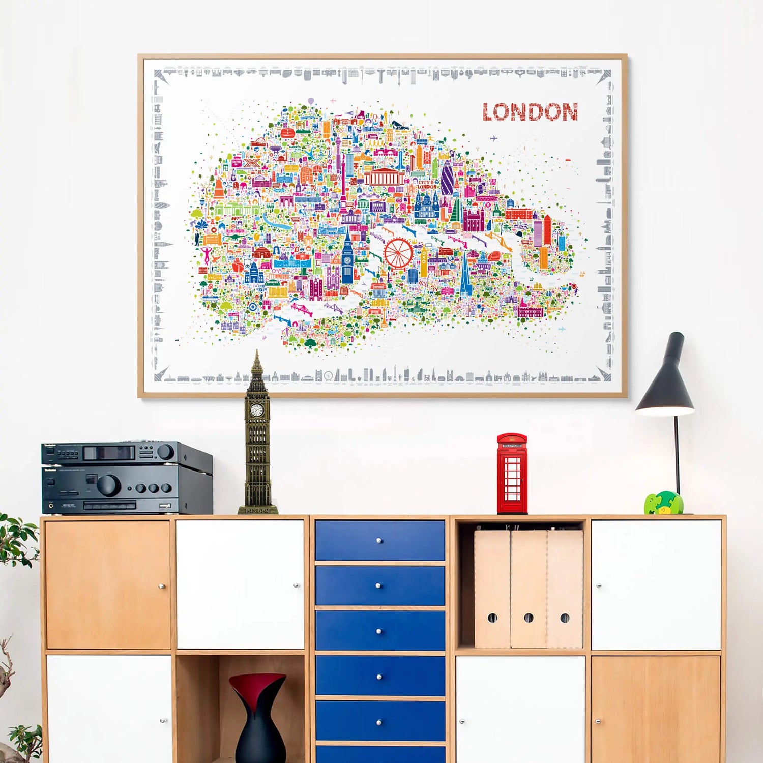 Colorful map of London on a wall above a wooden cabinet with decorative items.