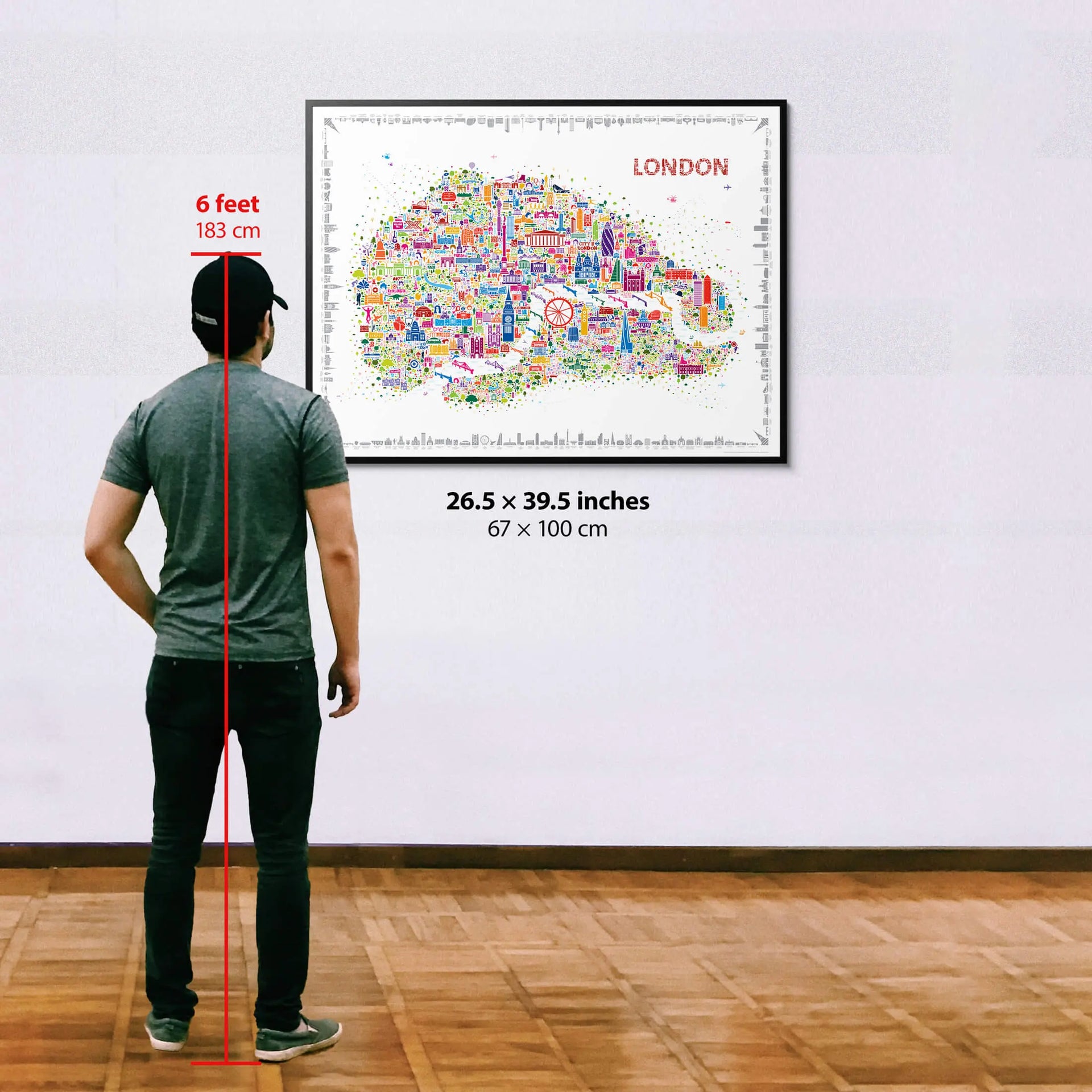 Person standing next to a framed map of London with dimensions displayed.