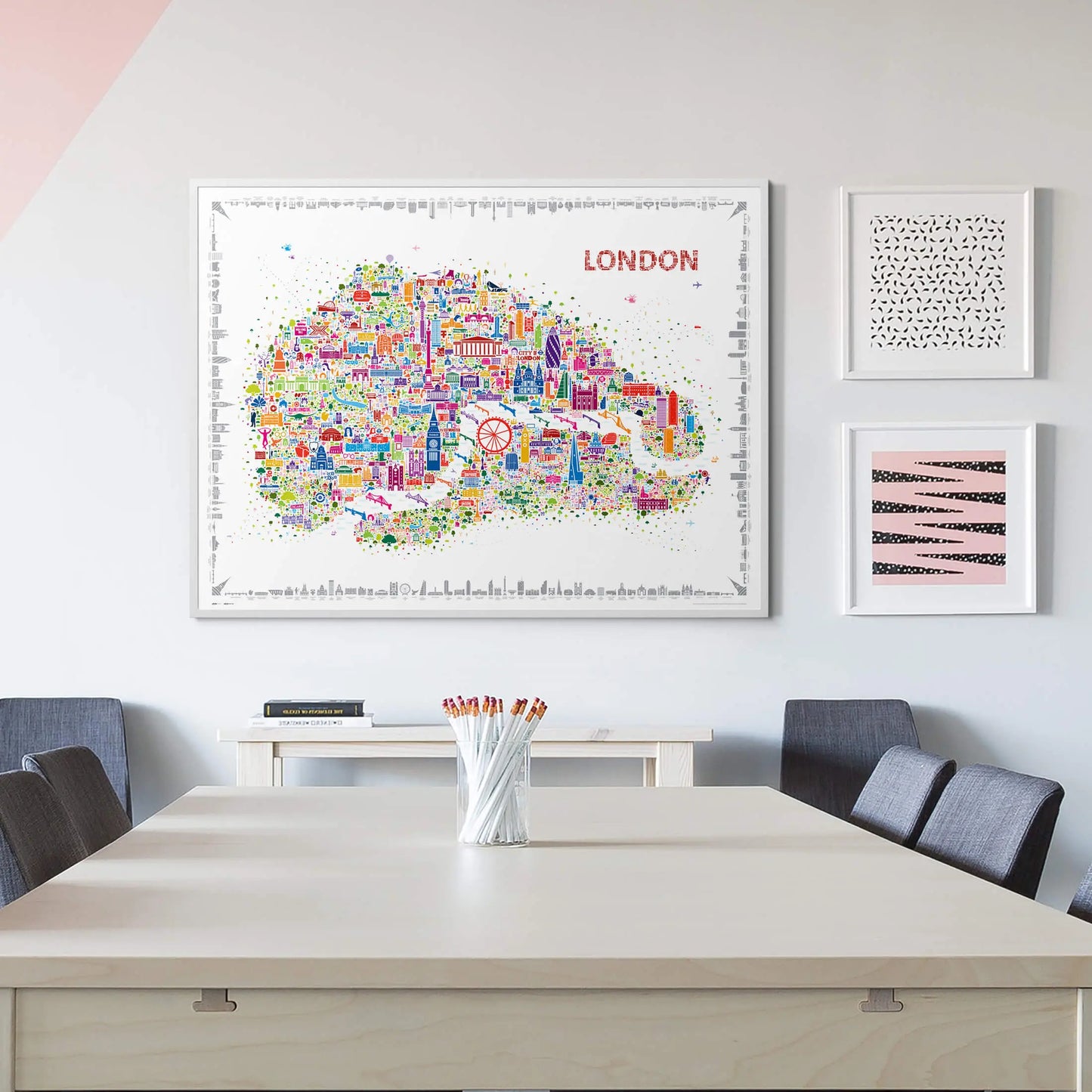 Colorful London map poster on a wall above a table with chairs.