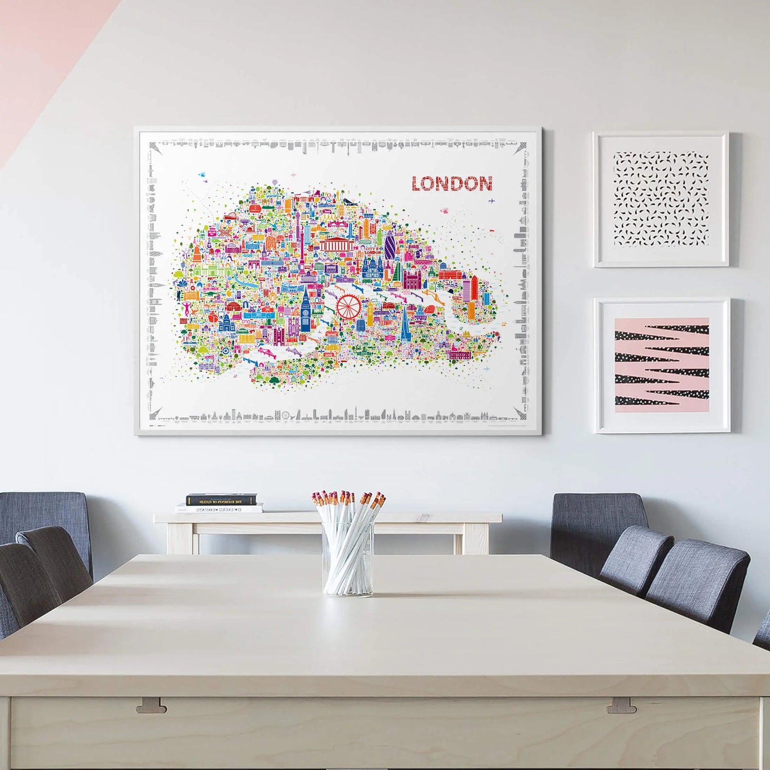 Colorful London map poster on a wall above a table with chairs.