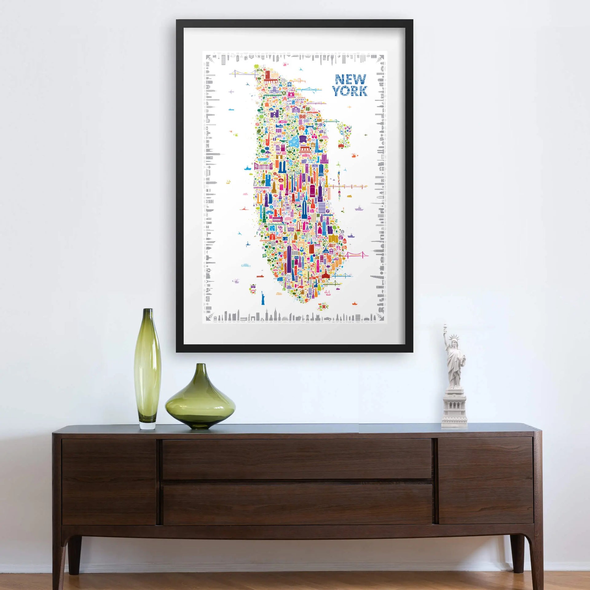 Framed colorful map of New York on a wall above a wooden console table.