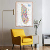 Colorful New York map on a wall above a yellow armchair in a room with a lamp and small table.
