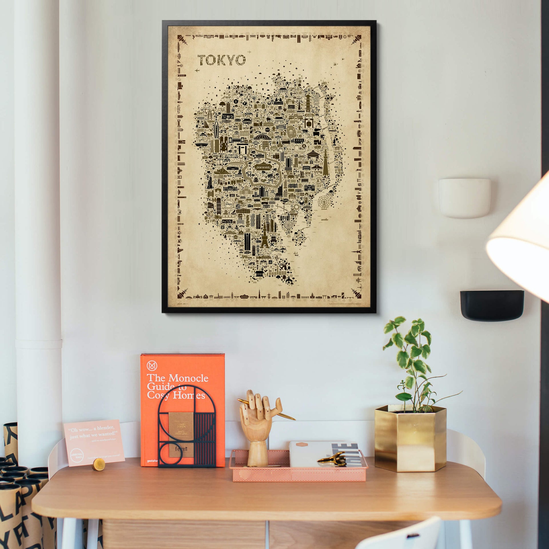 Iconic Tokyo Antique map poster in a black frame displayed in a modern home office with wooden desk and creative supplies