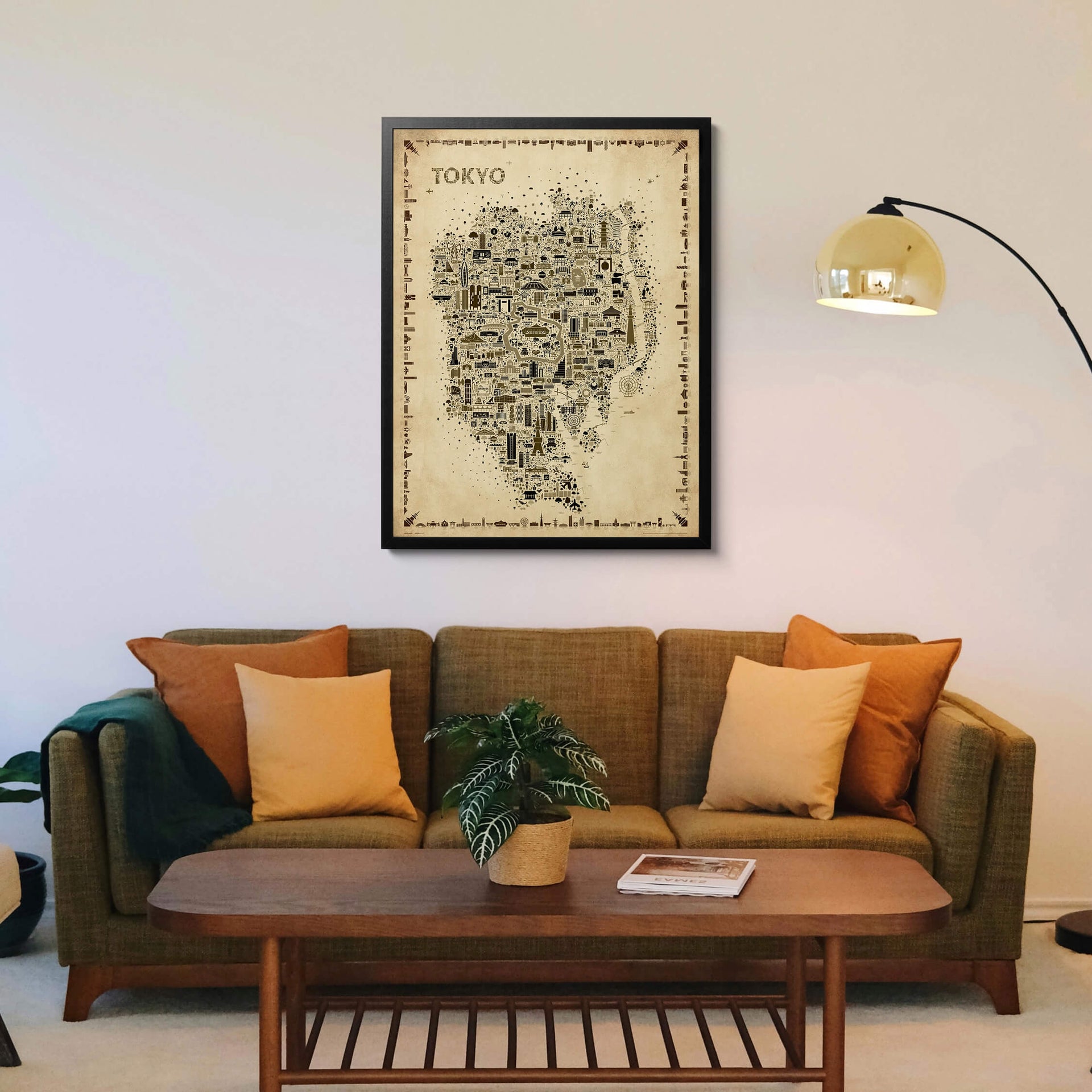 Iconic Tokyo Antique map poster in a black frame displayed above an olive green sofa in a refined living room setting