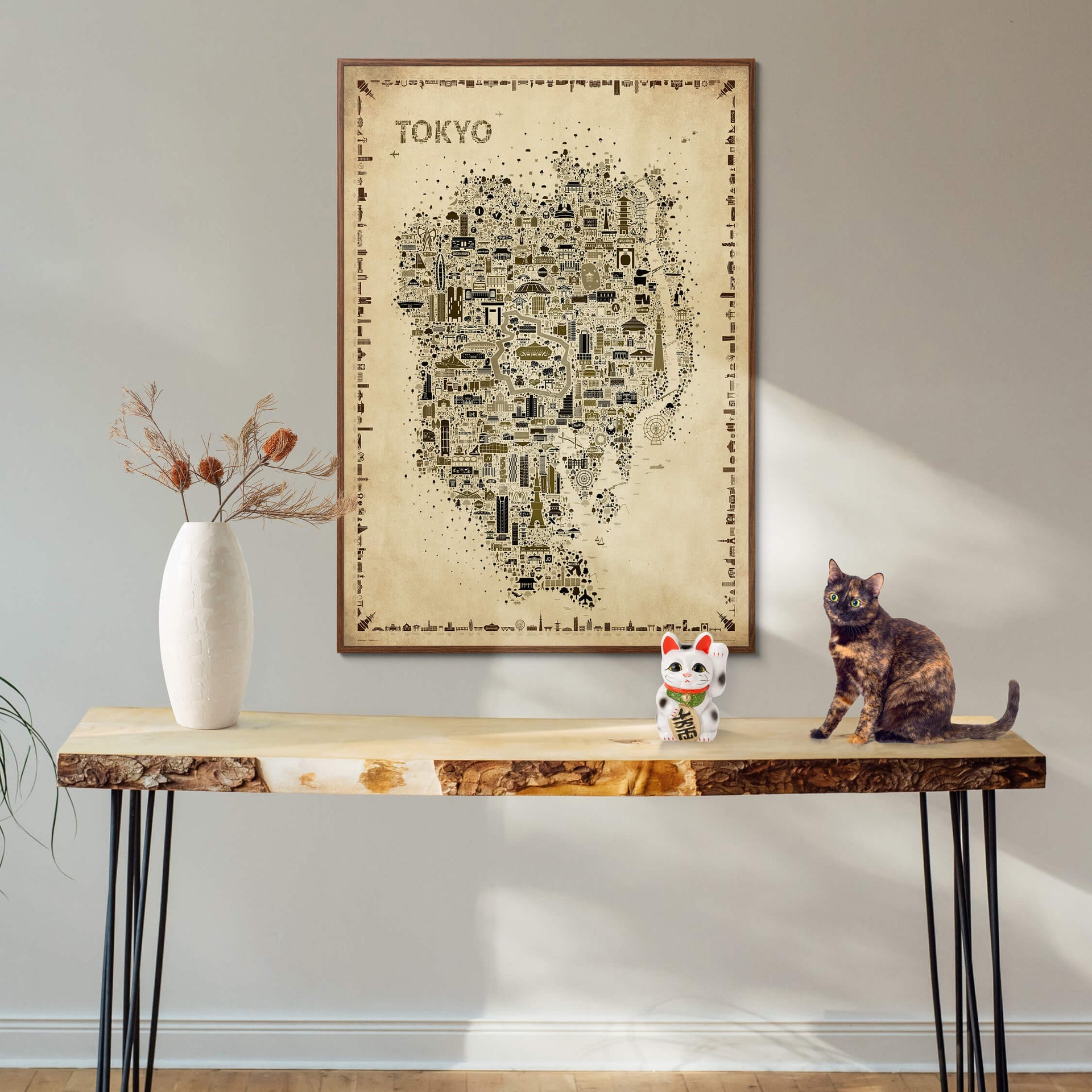 Iconic Tokyo Antique map poster in a dark wood frame above a console table with a Japanese lucky cat and a tortoiseshell cat