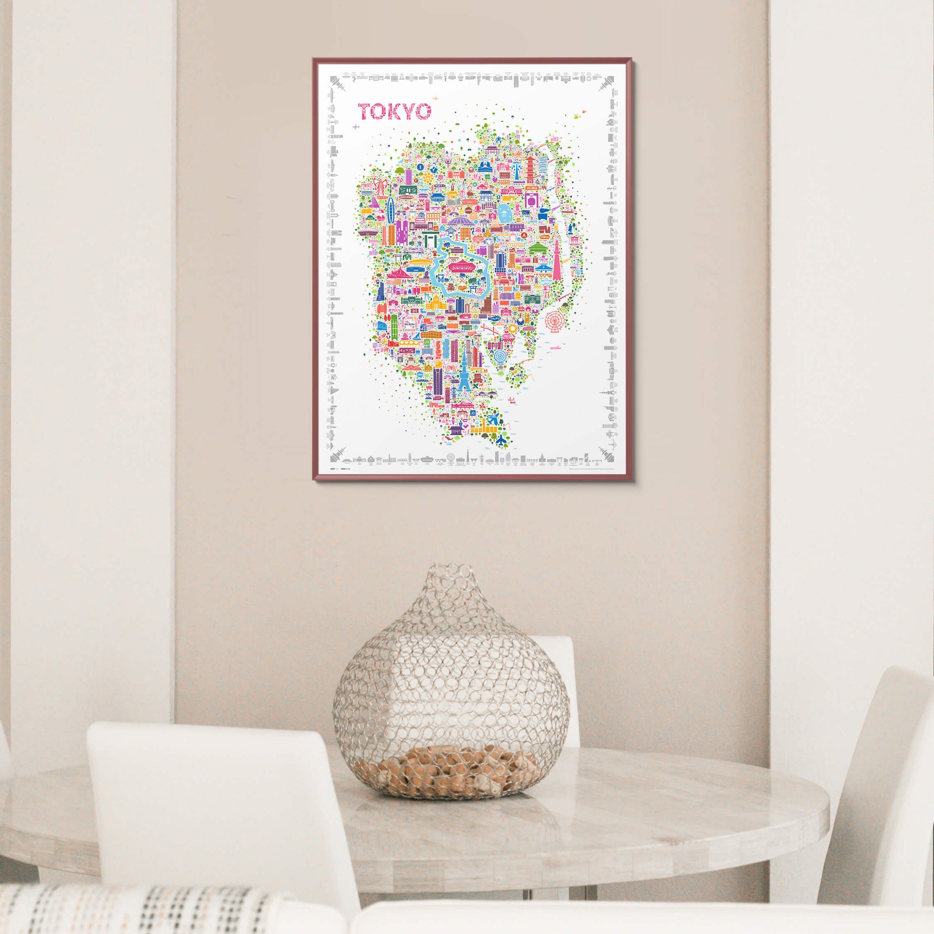 Iconic Tokyo poster in a dark wood frame styled in a warm modern dining room, colorful city map wall art contrasting soft neutral interiors