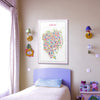 Colorful Iconic Tokyo map poster in a light pink frame hanging in a pastel kid’s room, playful and artistic wall décor with soft violet and pink interior styling