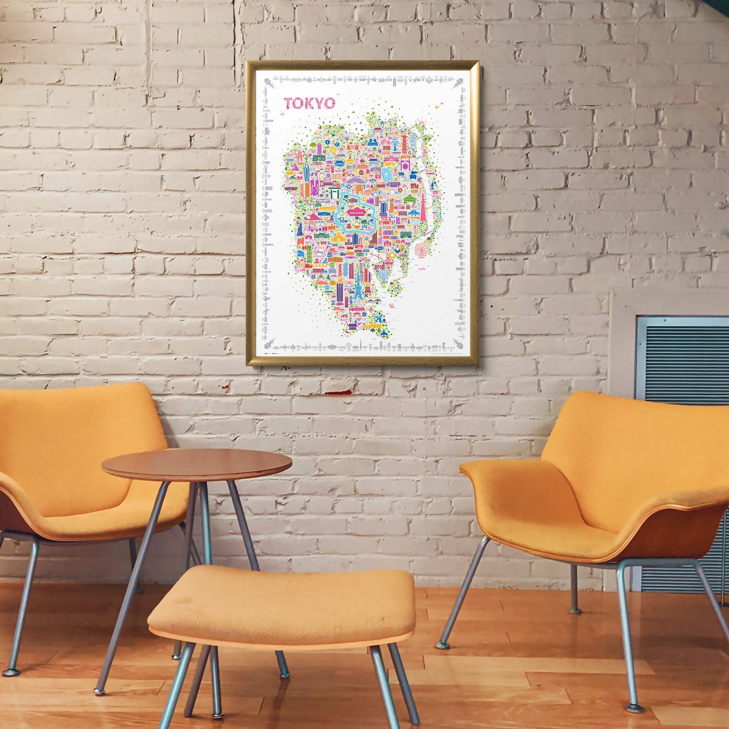 Iconic Tokyo map poster in a gold frame hanging in a modern startup lobby with textured brick wall and bright yellow furniture