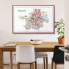 Colorful map of Kolkata framed on a wall above a wooden table.