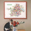 Colorful map of Kolkata on a wall with a cat and flowers on a table below.