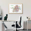 Colorful map of Kolkata framed on a wall above a desk with office furniture.