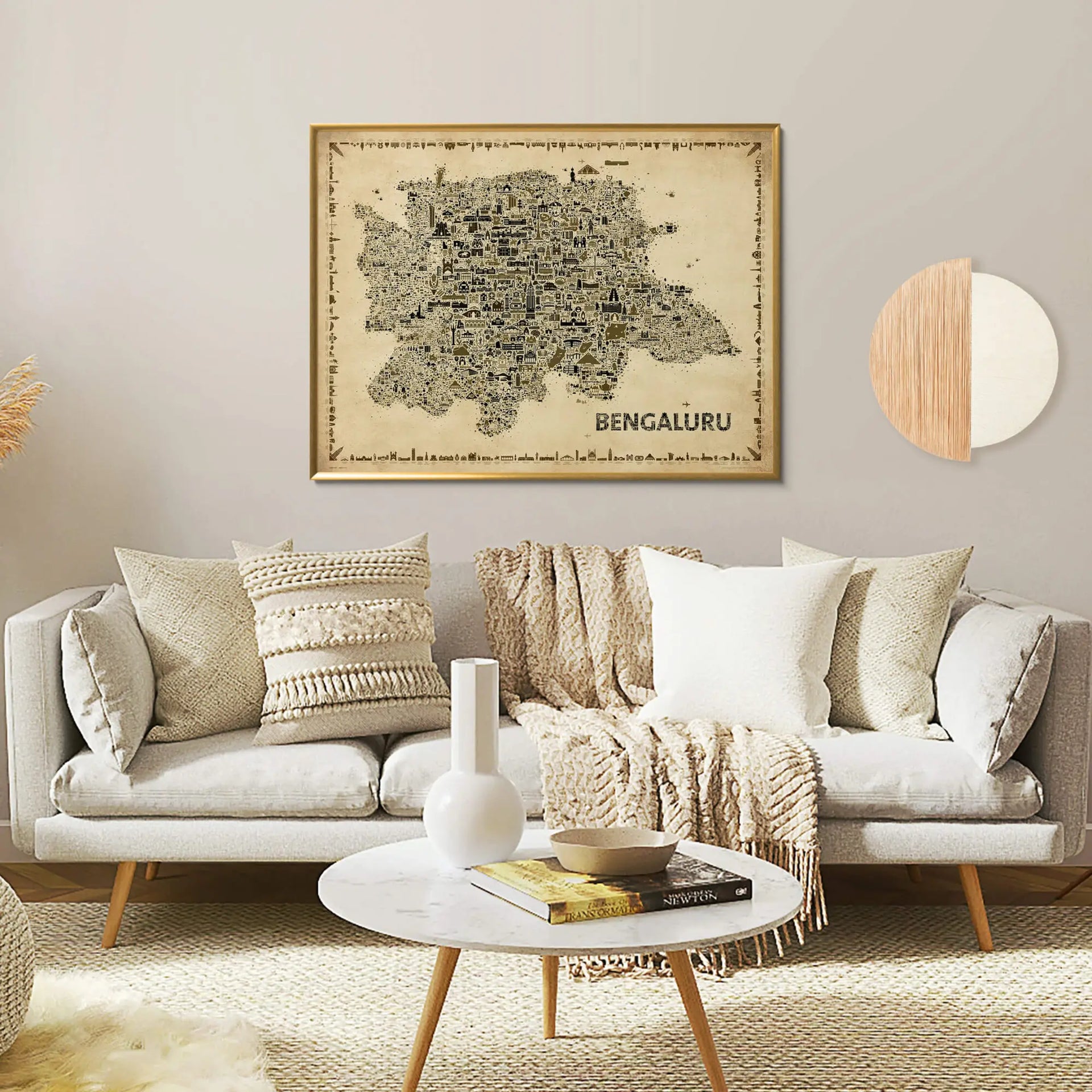 Living room with a gray sofa, decorative pillows, and a framed map of Bengaluru on the wall.