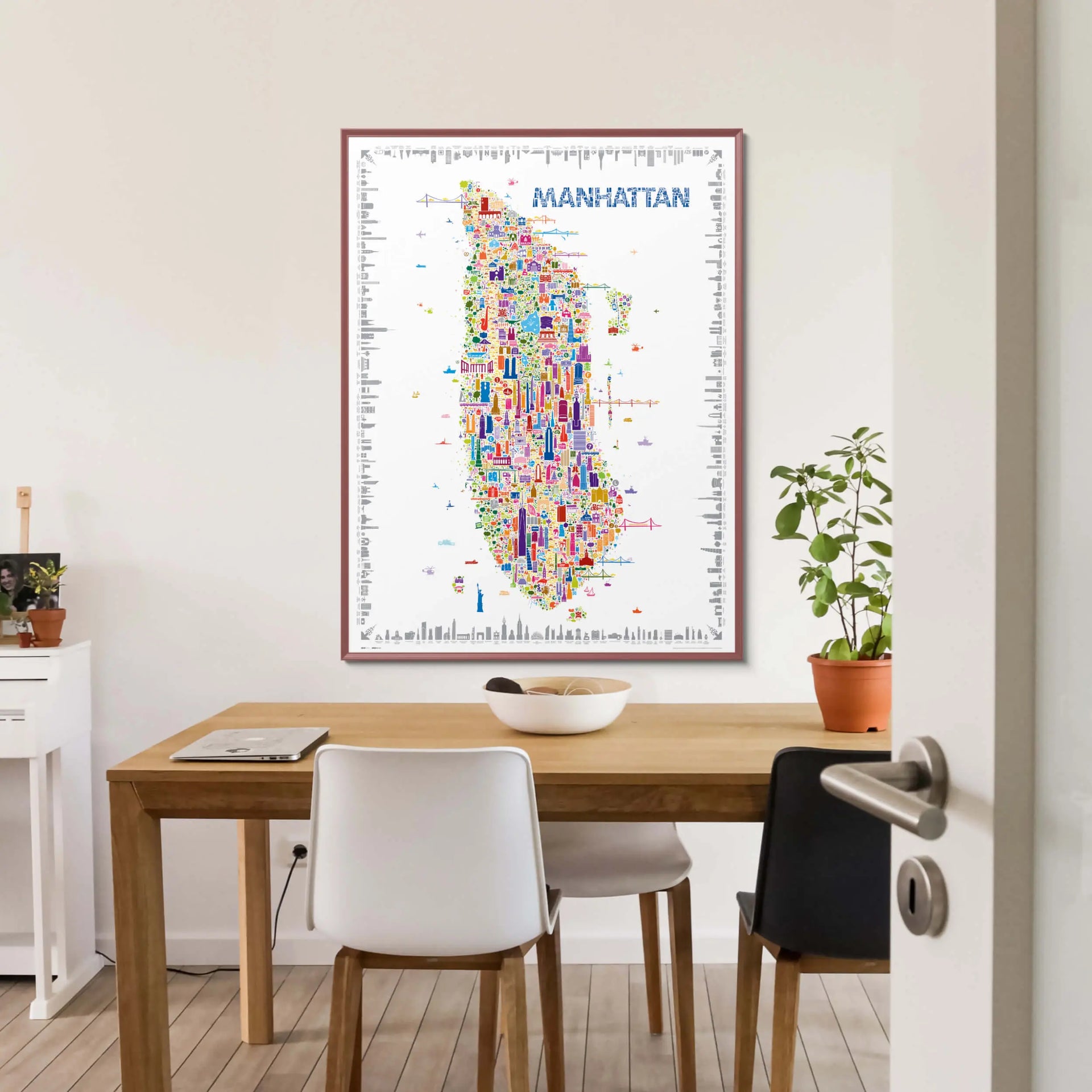 Colorful Manhattan map on a wall above a wooden table with chairs.