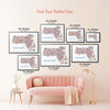 Colorful Massachusetts illustrated map poster size guide displaying seven framed print sizes above a blush pink sofa.