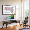 Modern Massachusetts illustrated map poster displayed as stylish home office wall art above a desk. Colorful travel map artwork featuring Boston and New England landmarks designed as contemporary décor.