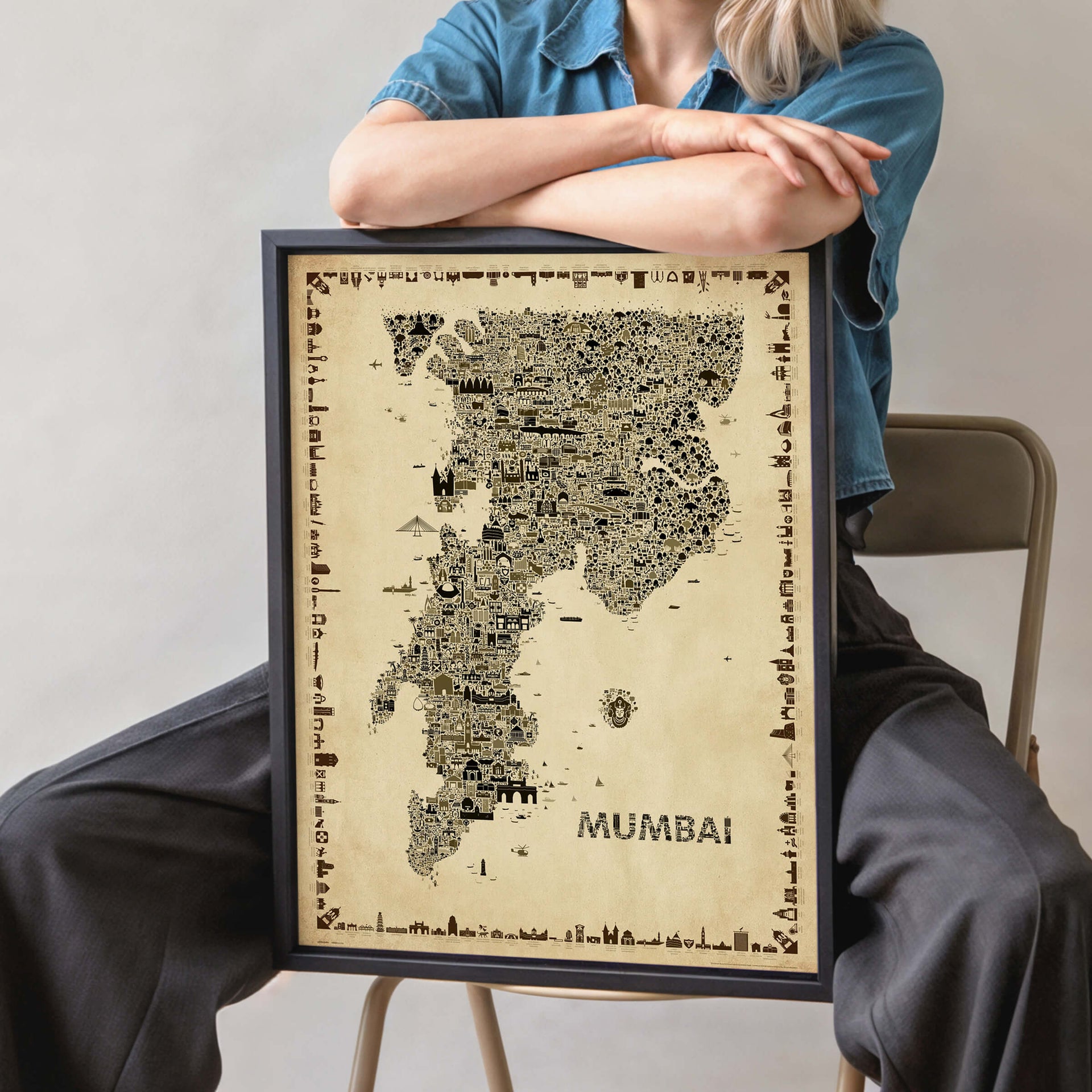 Person holding framed Mumbai antique map poster showing scale and detail of wall art print