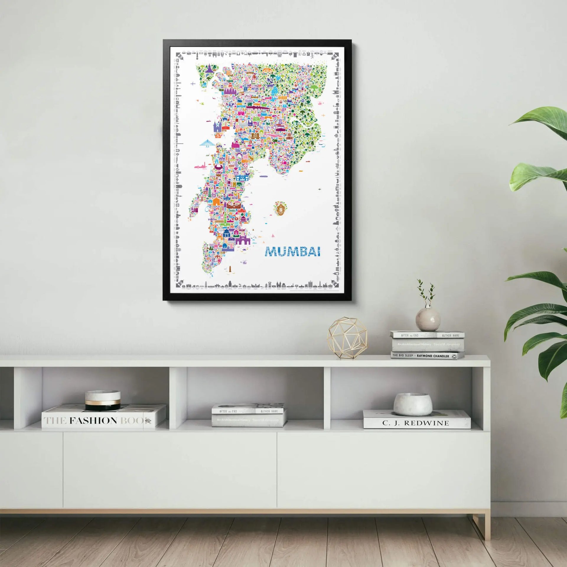 Framed map of Mumbai on a wall above a white shelf with decorative items.