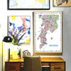 Colorful map of Mumbai on a wall above a wooden desk with decorative items.