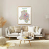 Living room with a sofa, coffee table, and decorative items, featuring a colorful map of New Delhi on the wall.
