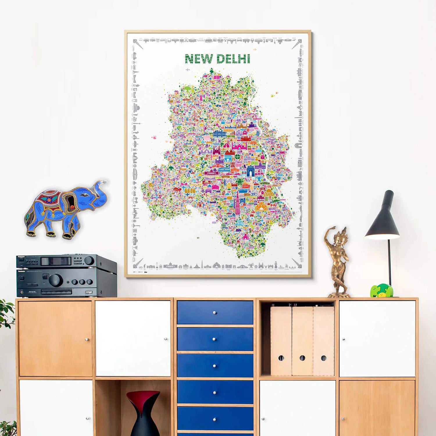 Colorful map of New Delhi on a wall above a wooden cabinet.